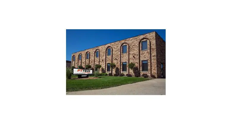 A large brick building with many windows on the side.